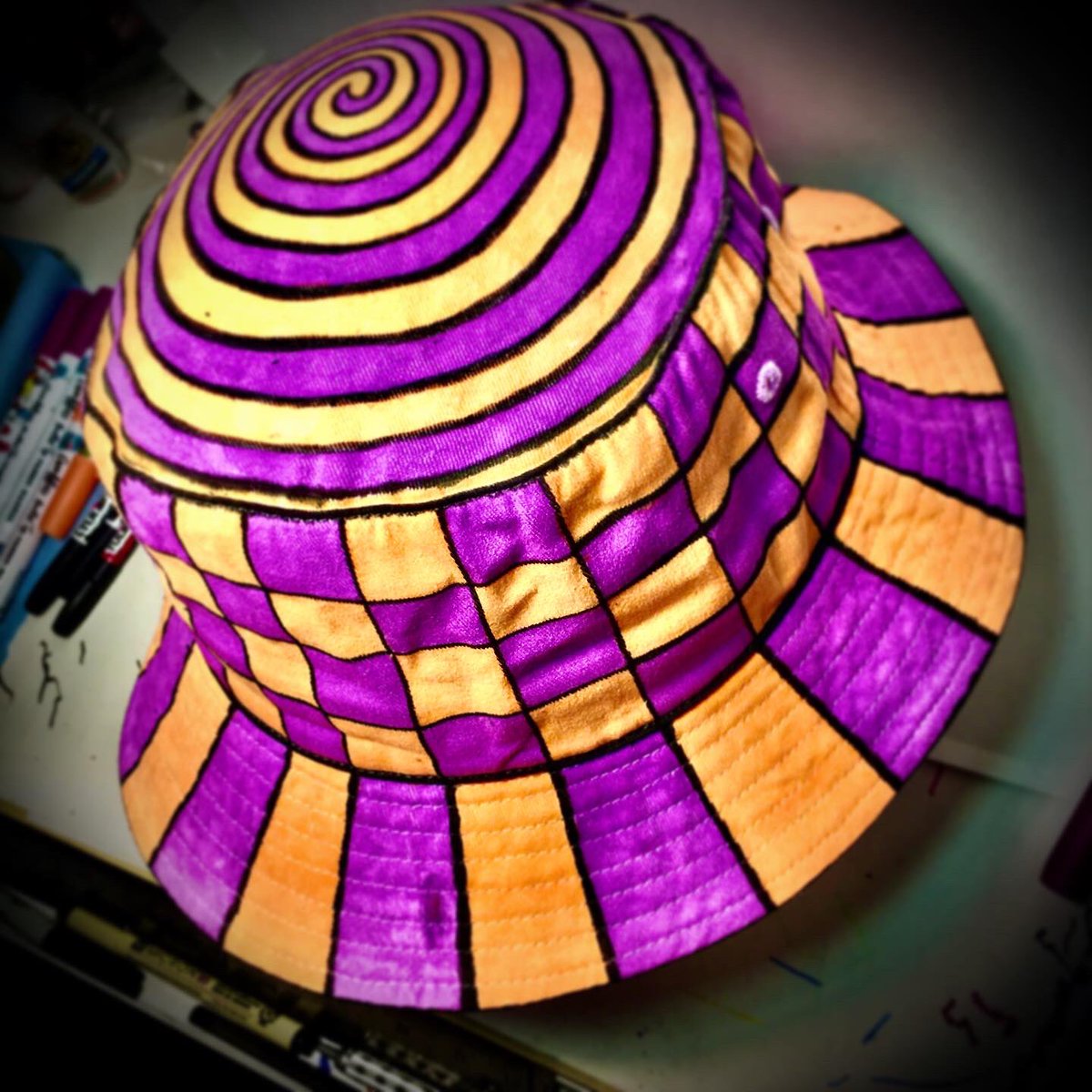 BrianABernhard's tweet photo. I just finished hand painting a new purple and orange checkerboard patterned #buckethat with a spiral on top! This one of a kind weirdo head wear will be available to collect in my @abrand4weirdos gallery inside @craftedportla this weekend!
#WeirdHat #paintedhat https://t.co/tZhg0Av3zW
