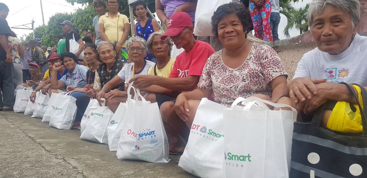 SmartNewsroom's tweet photo. Communities affected by Typhoon #UrsulaPH in Aklan receive relief assistance from PLDT-Smart Foundation, Smart Communications, provincial distributor Koks and regional distributor One World. #SafePH https://t.co/TFUGSNGc7V
