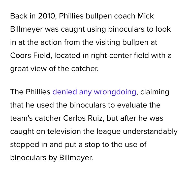 2010 Phillies. Bullpen coach sitting in center field with binoculars.