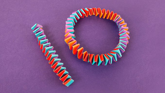 The number 10, written using colorful criss-crossing strips of folded paper.