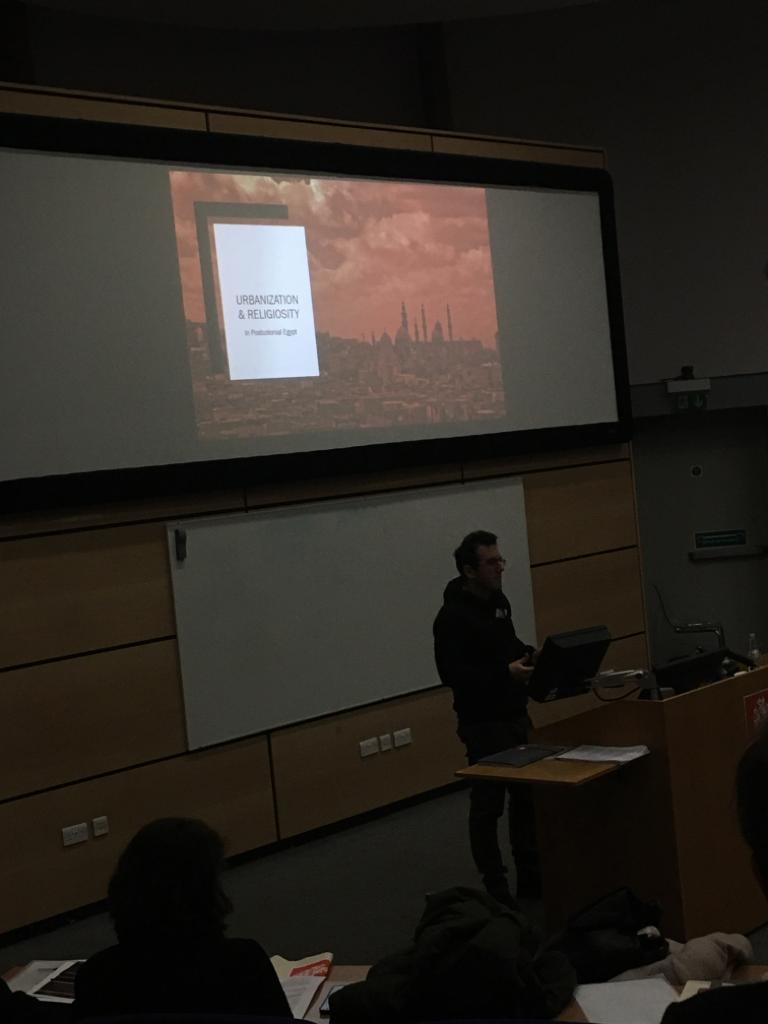 CIWAS_RHUL's tweet photo. Our final speaker for the second panel on identity and urban Islam, Panos Kourgiotis (University of Macedonia, Thessaloniki) giving his fascinating talk ‘From Tarîqa to Jamā ‘iyya; Urbanization and Religiosity in Postcolonial Egypt’. #CIWAS https://t.co/m32HUPnt45
