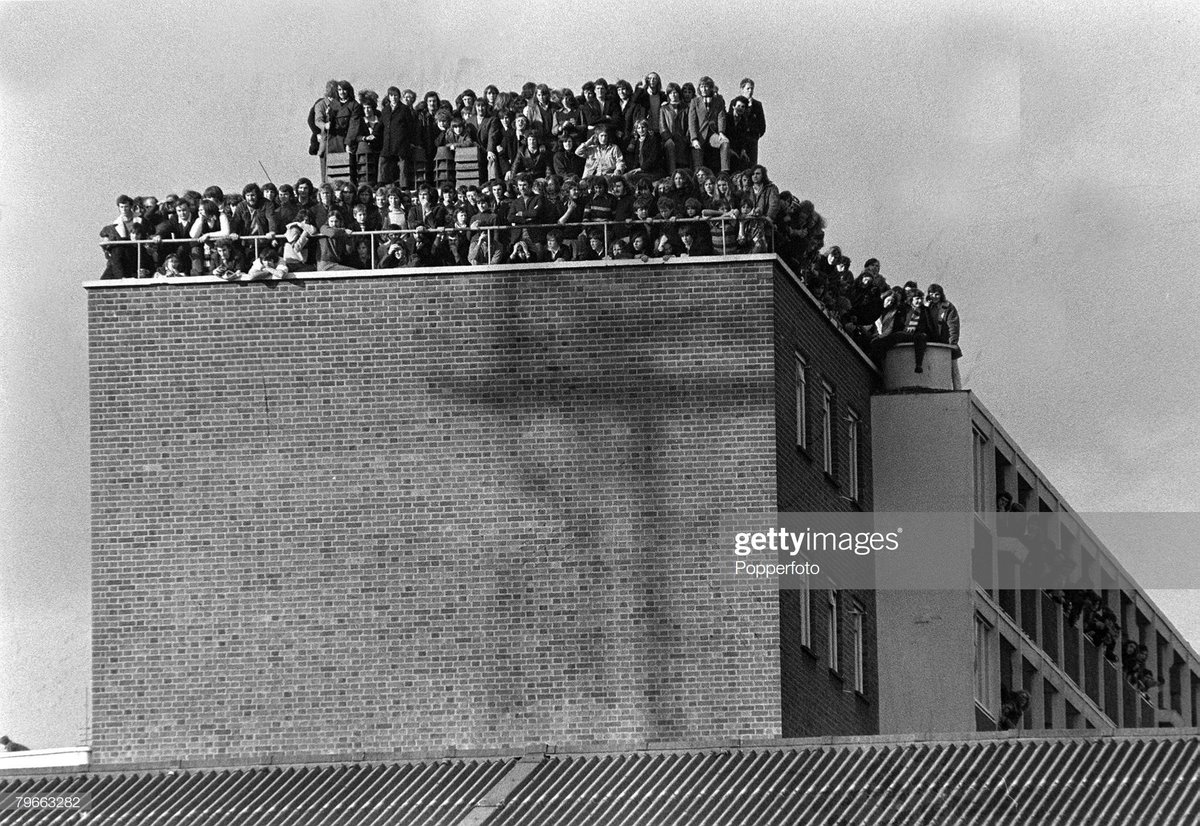 Fans crowd the roof of a block of flats overlooking West Ham's Upton Park as the Hammers win their FA Cup replay v Hereford 3-1, February 1972.Photo Popperfoto