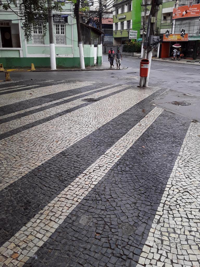These ornate pavements are one of the distinctive features of Brazilian cities, and consist of millions of pieces of stone which have been hammered gently by hand to form designs varying from perfectly straight lines...