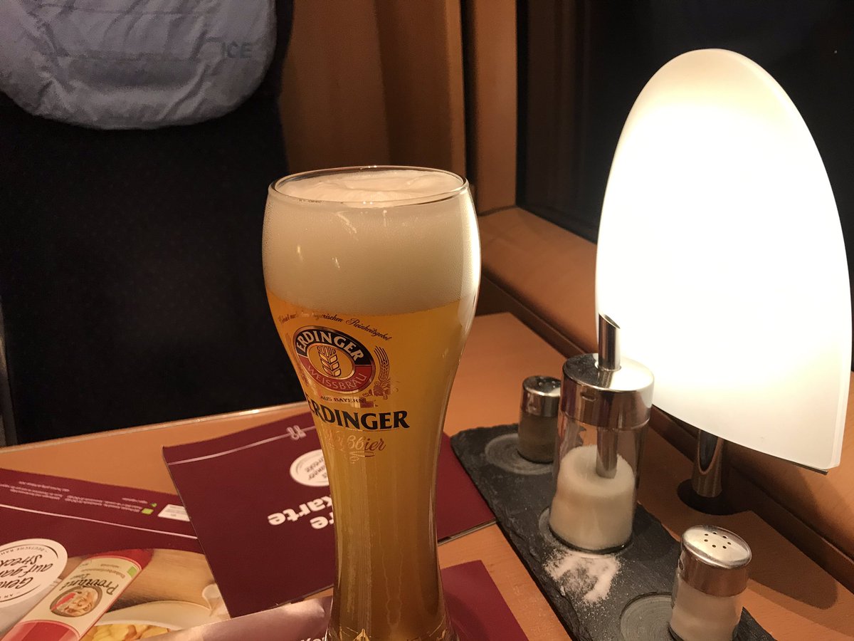 Enjoying a celebratory 0.5 litres of Weissbier from an actual glass in the bistro car as we cross the Belgian border
