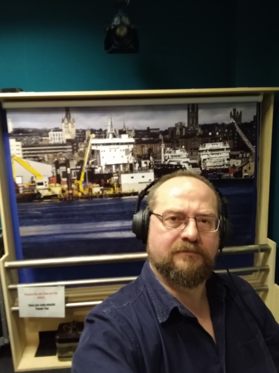 Thoughtful News-reading Stuart poses thoughtfully in front of the fake Aberdeen backdrop at the BBC. @GraniteNoirFest