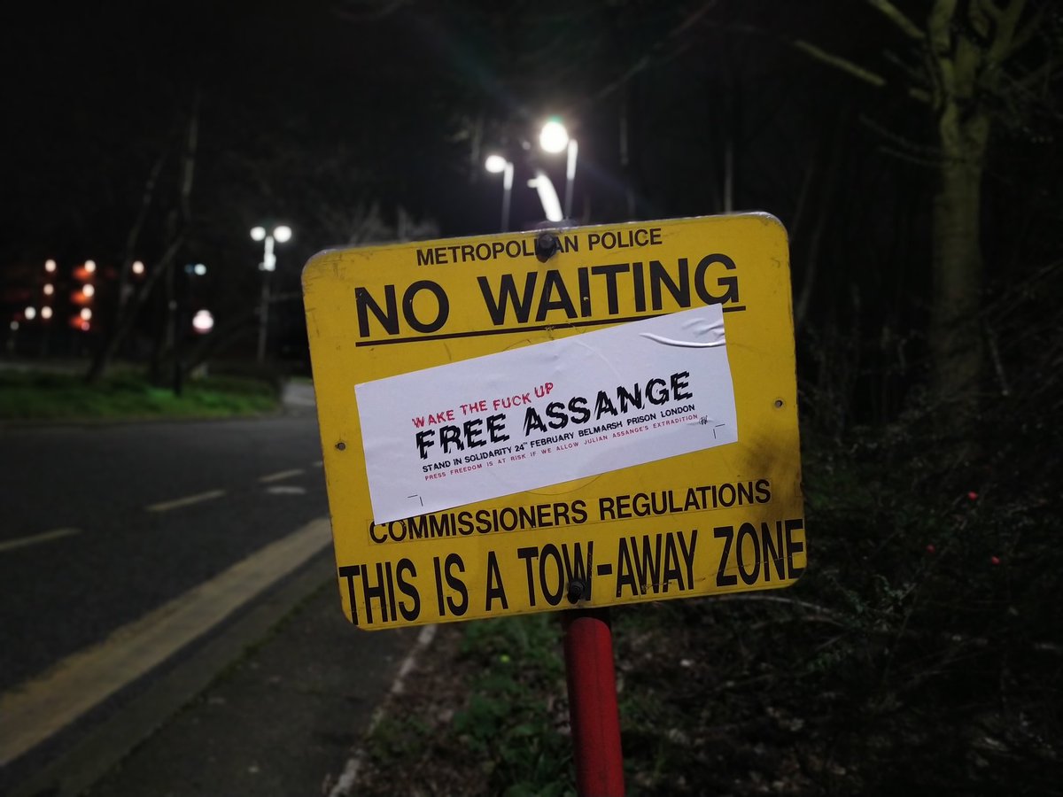 MElmaazi's tweet photo. Posters, stickers, and banners can be found throughout the area, calling on people to "Wake up and give a shit", "wake the fuck up" and "free #JulianAssange". https://t.co/jAhYHGbo1a