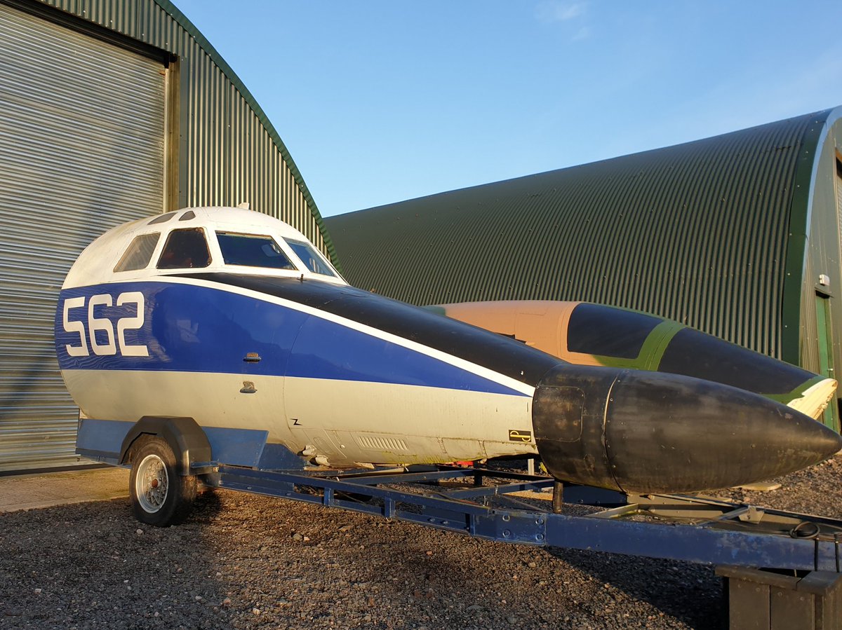 Front end of a Jetstream aircraft mounted on a trailer sat at the museum in front of a Romney Shed.