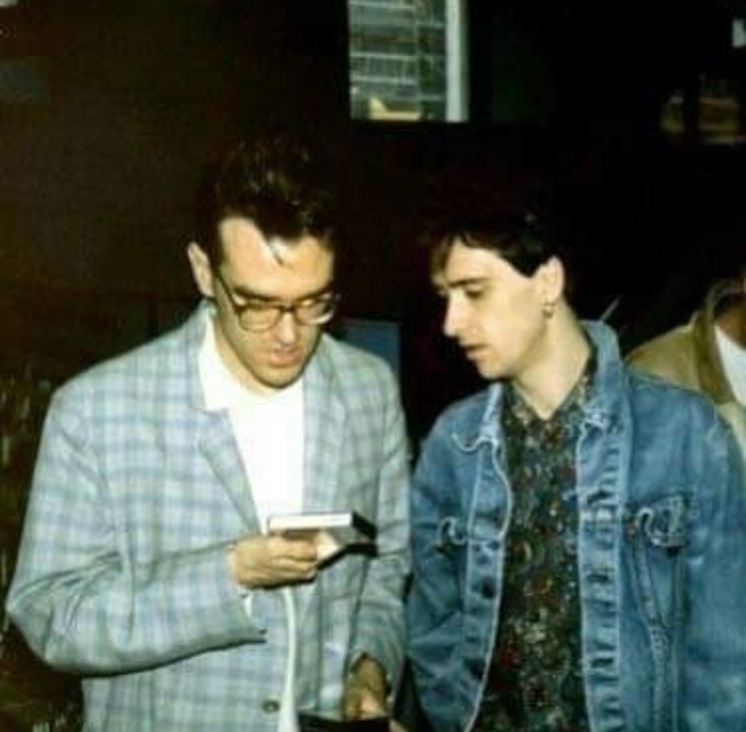 mozholdingstuff's tweet photo. Morrissey holding and looking at a cassette tape https://t.co/9vGdG9QjIX