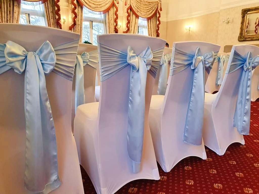 Sky Blue Satin Sashes with White Chair Covers set up at the <a href="/FaringtonLodge/">Farington Lodge</a> , Preston.