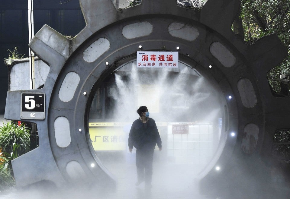 CyberpunkWatch's tweet photo. From Chongqing, China. Workers at this company are sprayed with disinfectant after entering this specially constructed tunnel. https://t.co/SCgUB91FHJ