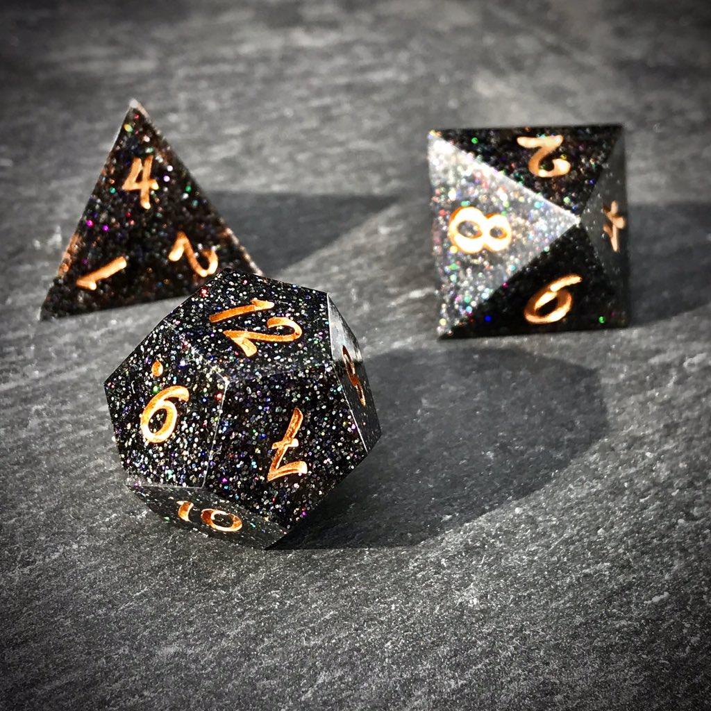 ThornlessRoseUK's tweet image. Glittering Black Smoke starts to appear, weaving its way between the wielders fingers. Power building the the spell is released upward, the faerie fire sparks raining down in a beautiful rainbow cascade.

Black holographic glitter #handmadedice set with odd #D20
#ttrpg #dnd #dice