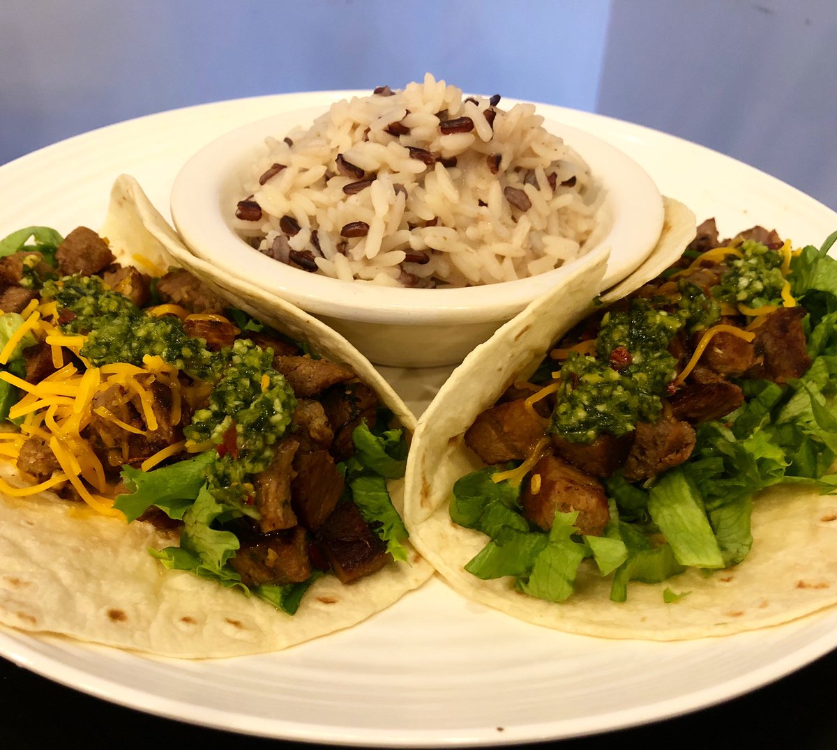 CHIMICHURRI TACOS — Chimichurri tacos with steak, cheddar cheese, lettuce, and chimichurri sauce $10 with side of rice