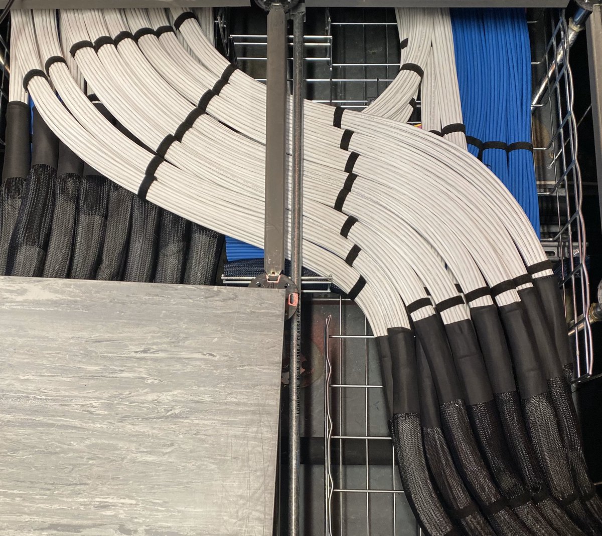BSCLltd's tweet photo. Heat shrink sleeve being applied to each end of the cable sock to keep it secure and stop any movement. 

#datacentre #cat6a https://t.co/ydnAl5L97V