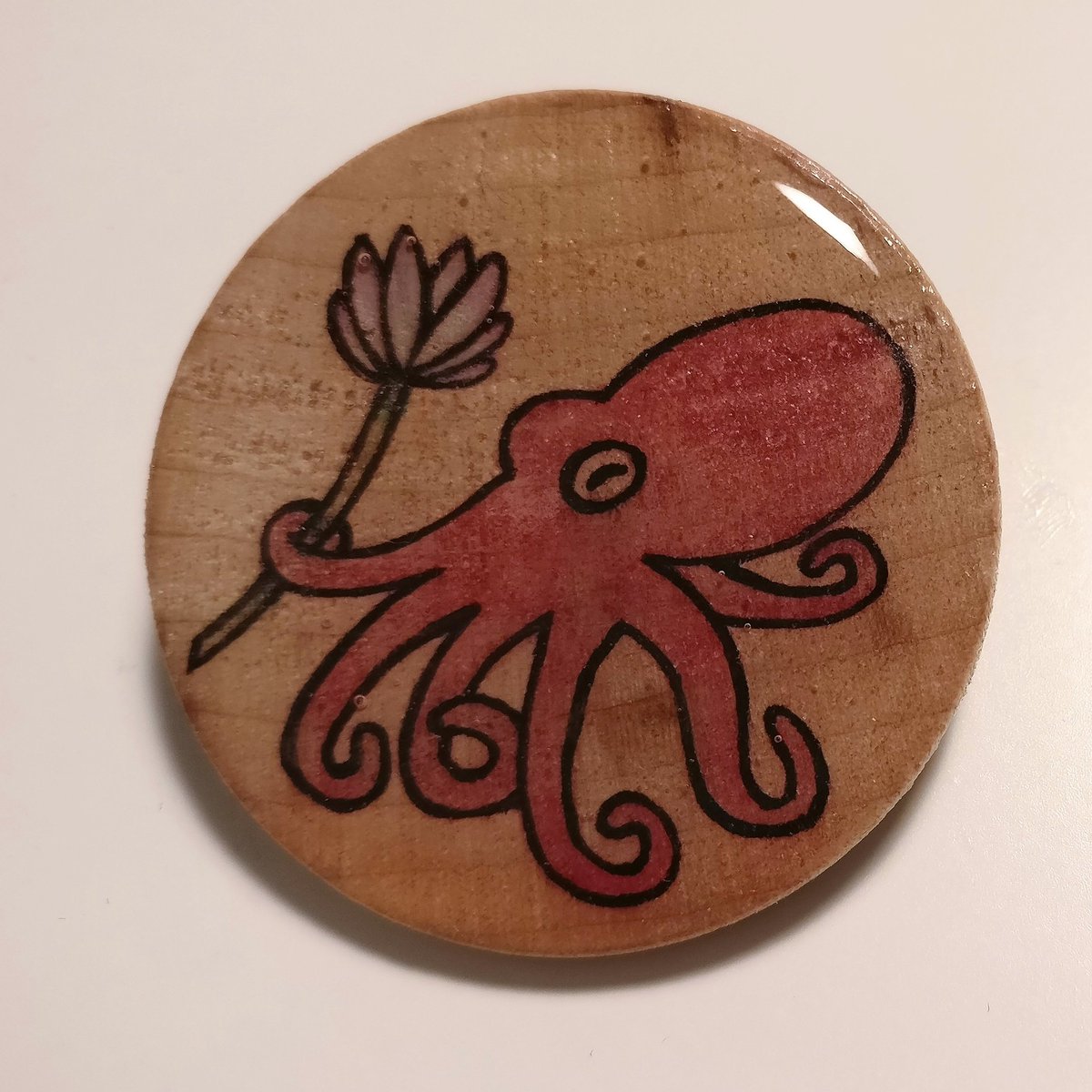 jenayy's tweet photo. @thisishannako Hi I hope I'm doing this right! I hand draw stuff on wood and then turn em into pins :) experimenting with sealing the art in with uv resin rn... this was a commission for a friend. my Instagram handle is bearcatdesign! https://t.co/clchQn8Ivg