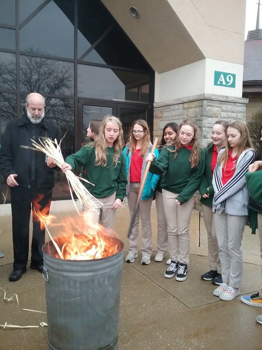 8th grade helping Fr. Todd burn the palms.