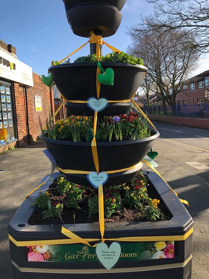 garforthinbloom's tweet photo. The ladies of Garforth WI have made green hearts to promote love for our planet &amp; to stimulate talk about climate change. You can find them on our tiered planter in Main Street. They are free, please take one. #bloomhour https://t.co/SjCcxg8sSI