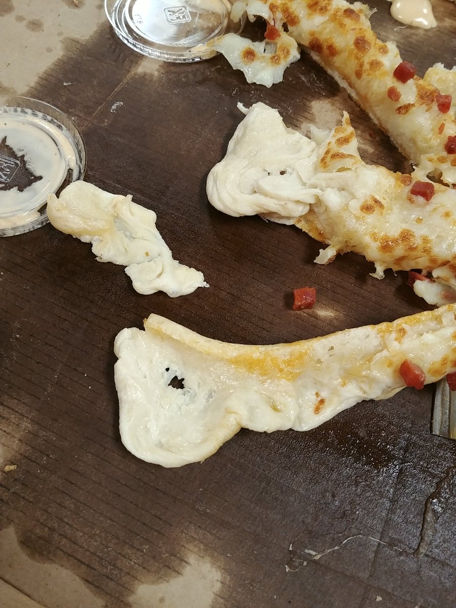 Leaite's tweet photo. @ToppersPizza  do you guys just not cook your Topperstix? This is two days in a row it's been dough instead of crust. Lincoln, NE branch treated me like crap, even after giving you the benefit of the doubt and ordering again. https://t.co/itGXed8gAT