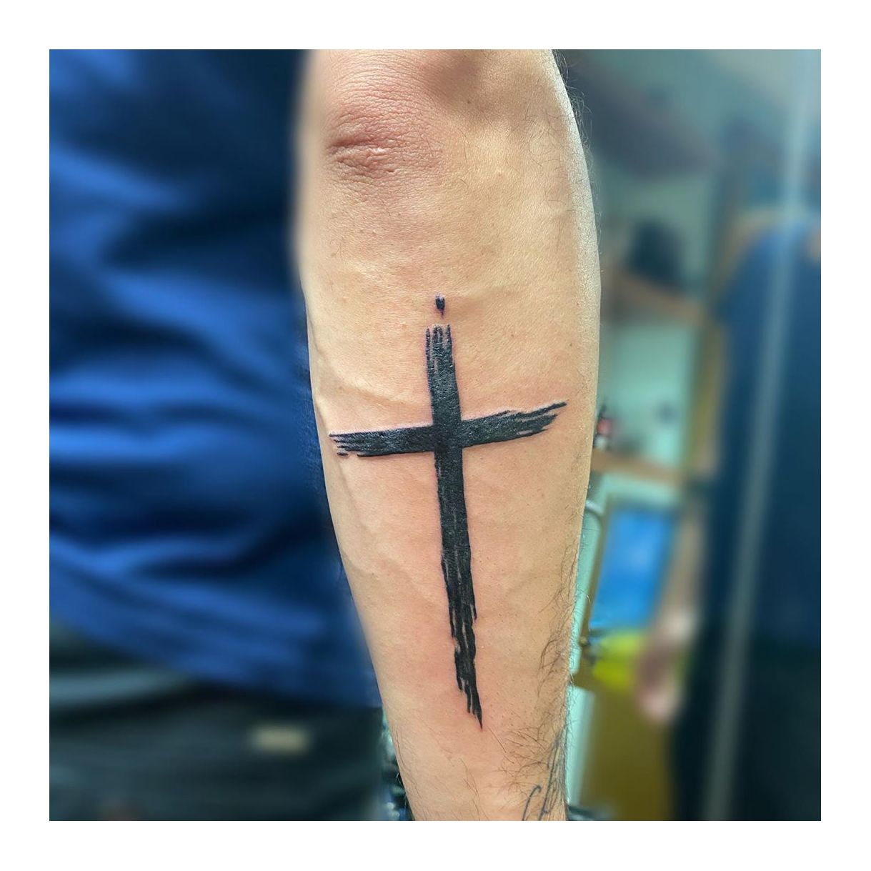 calf cross tattoo for women