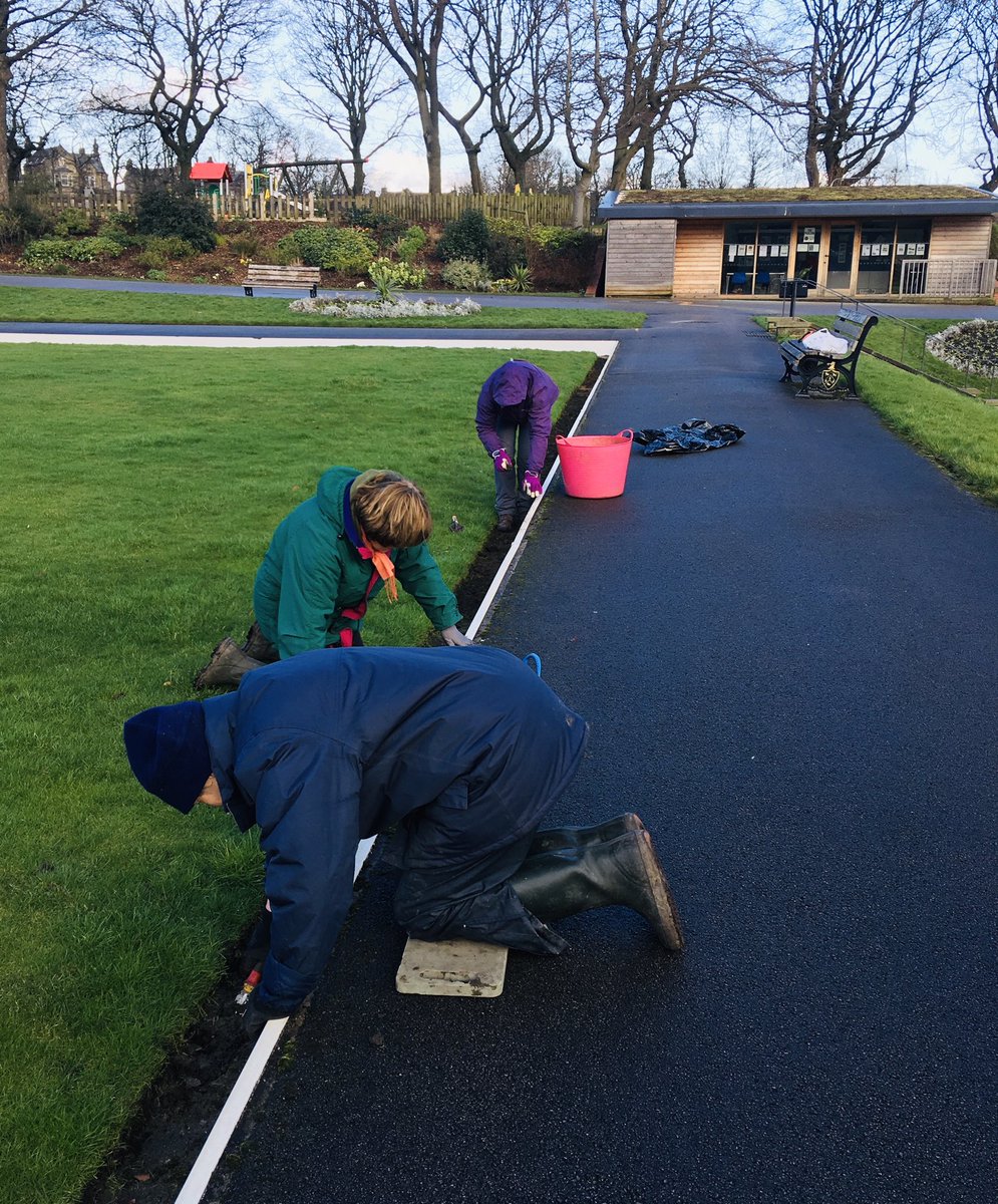 Here we are clearing leaves and weeds from around the bowling greens - in between sleet showers!