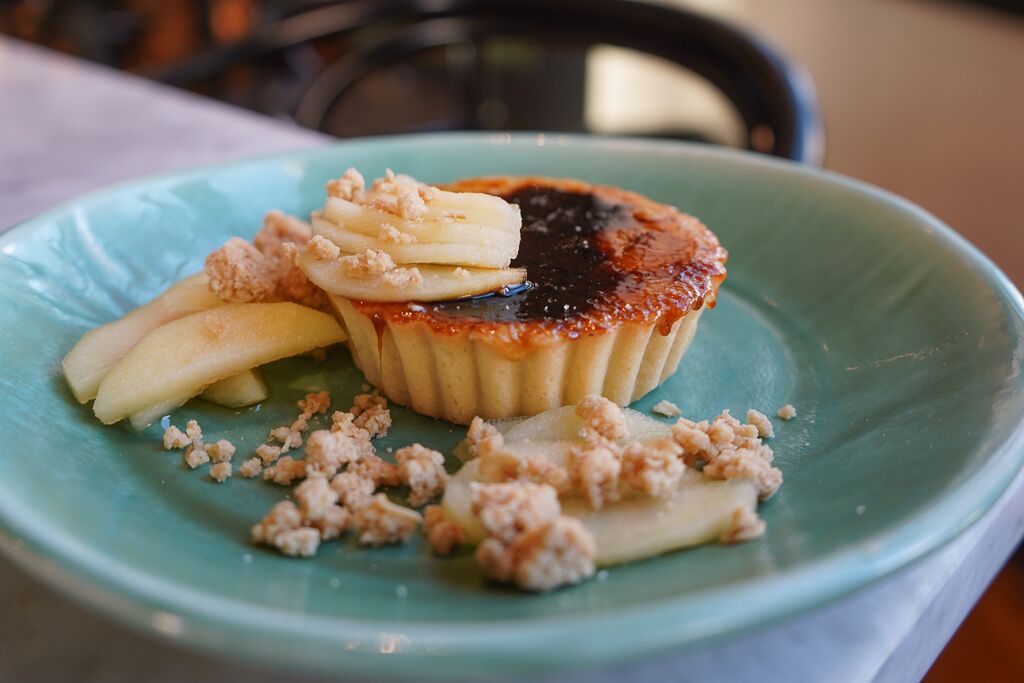 Our Burnt Maple Tart gets a little salty alongside the sweet with cider-poached apples and salted oat crunch.