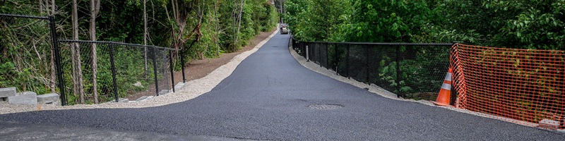 Image of the wide, accessible, paved trail that makes up the Lake to Sound Trail.