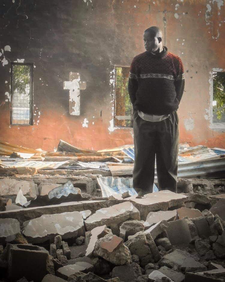 KEEP THE FAITH.

A Nigerian Christian stands in the rubble of his Church which was destroyed by Boko Haram.
He said: "Although we lost everything in the building fire, we have not lost our trust and faith in God.“