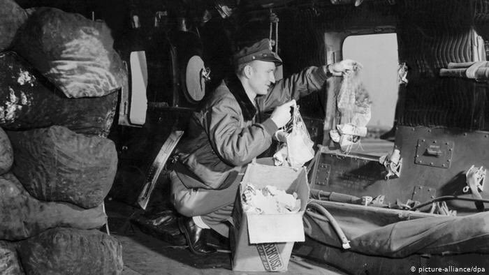 And then one day a 27 year old pilot named Hal Halvorsen broke the strict rules of the Airlift to begin secretly dropping candy tied to little handmade handkerchief parachutes to the children of Berlin.