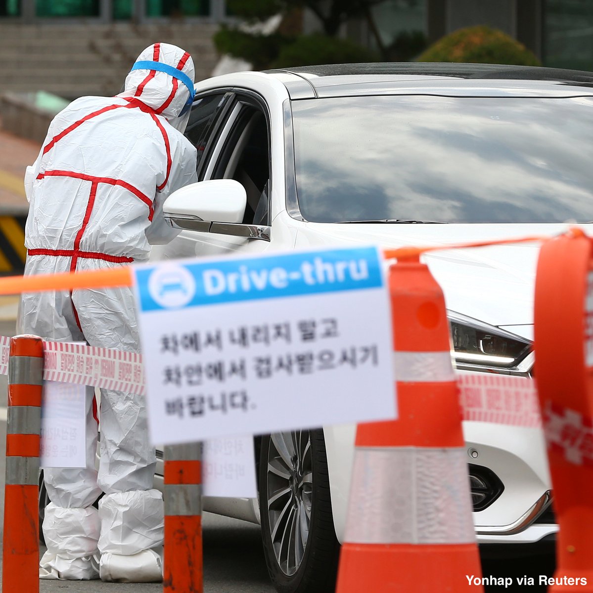 Medical staff take samples from passengers with suspected symptoms of coronavirus at a drive-through screening clinic of a hospital in Daegu, South Korea. abcn.ws/3cadsvw