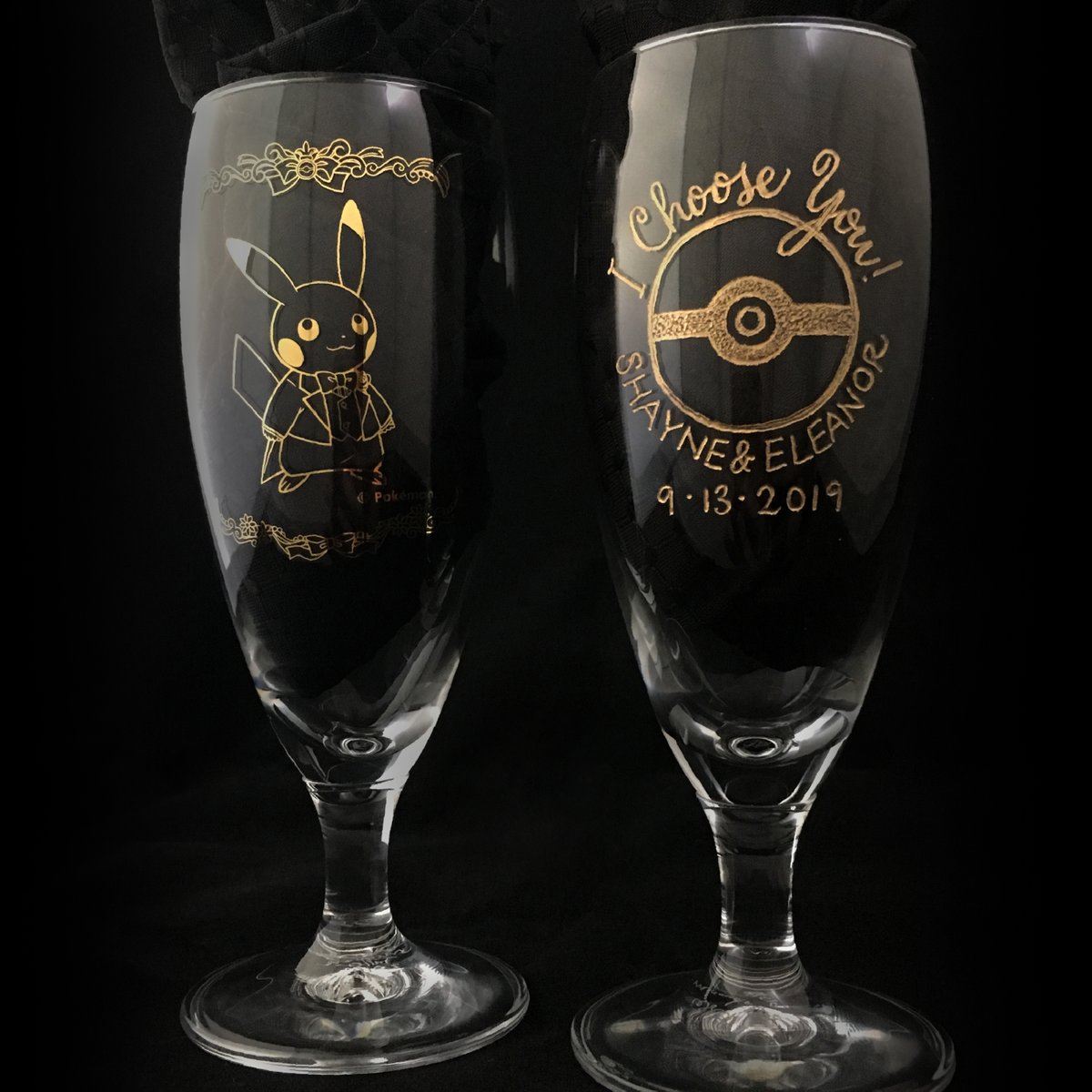 mirandafuller's tweet photo. Hand-engraved Pokémon champagne flutes special ordered from Japan, featuring a Pikachu bride and groom. #Pokemon #calligraphy #engraving #glassengraving #wedding #weddingseason #gifts https://t.co/5o2rPw4rbo