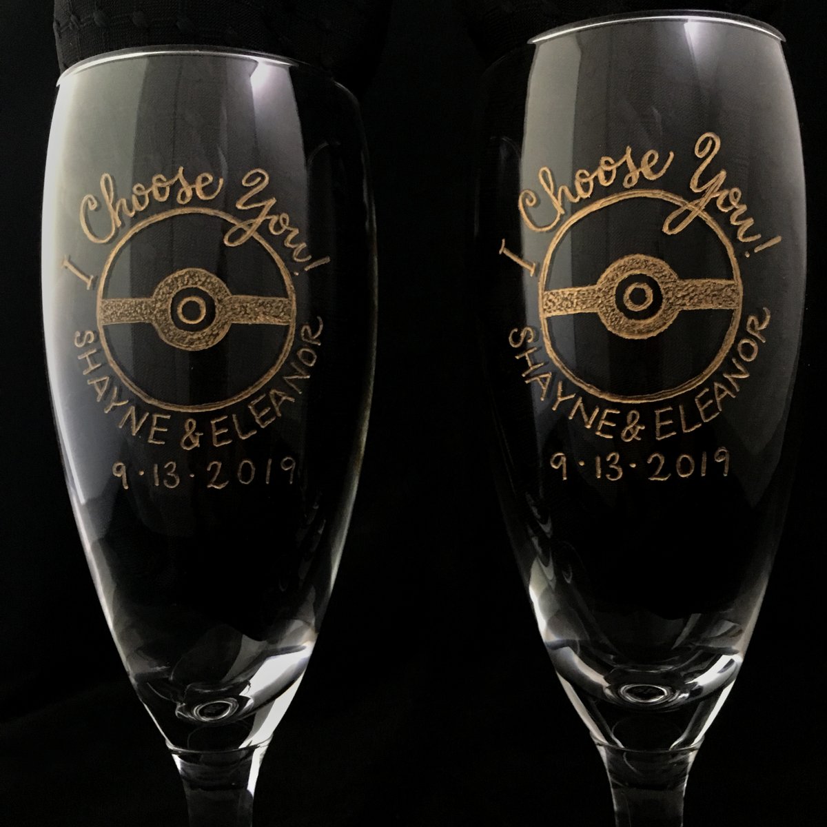 mirandafuller's tweet photo. Hand-engraved Pokémon champagne flutes special ordered from Japan, featuring a Pikachu bride and groom. #Pokemon #calligraphy #engraving #glassengraving #wedding #weddingseason #gifts https://t.co/5o2rPw4rbo