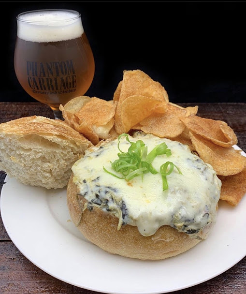One of our most popular GORE MET starters...the Creature Dip.
spinach-artichoke dip with torched mozzarella served in a sourdough bread bowl with kettle chips.