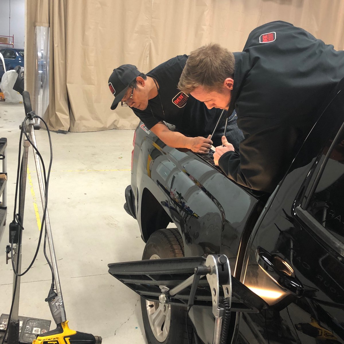 DentShopPDR's tweet photo. At Dent Shop we know that our team is crucial to our success.  Mark &amp; Tyler are rockstar dent technicians working together to fix a BIG DENT on this truck.  CALL NOW 571-293-2129 #team #together #teamwork #virginia #loudoun #dentrepair #paintlessdentrepair #truck #repair #usa https://t.co/IvEdRduT5O