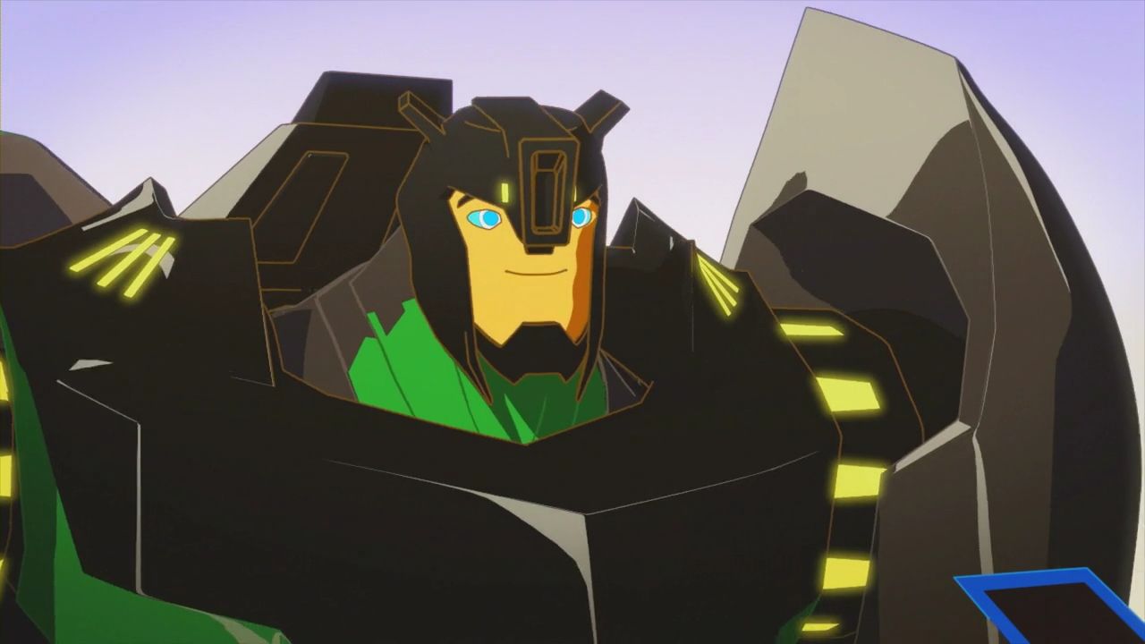 A screenshot of a cell-shaded 3D animated cartoon showing a black and green Transformer with a yellow faceplate and yellow biolights. He is very bulky, and he is smiling softly.