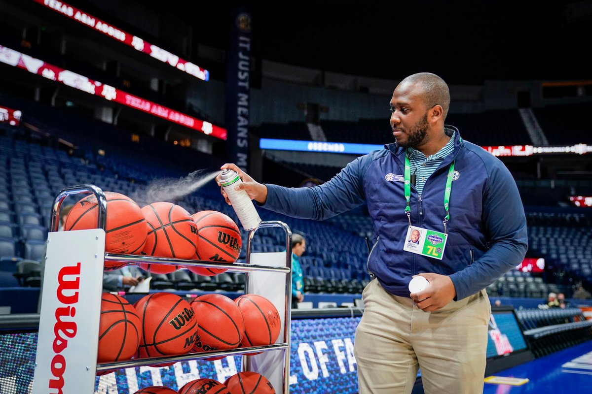SEC Staff sprays disinfectant on basketballs between practice sessions @bridgestone before the #SECMBB Tournament.