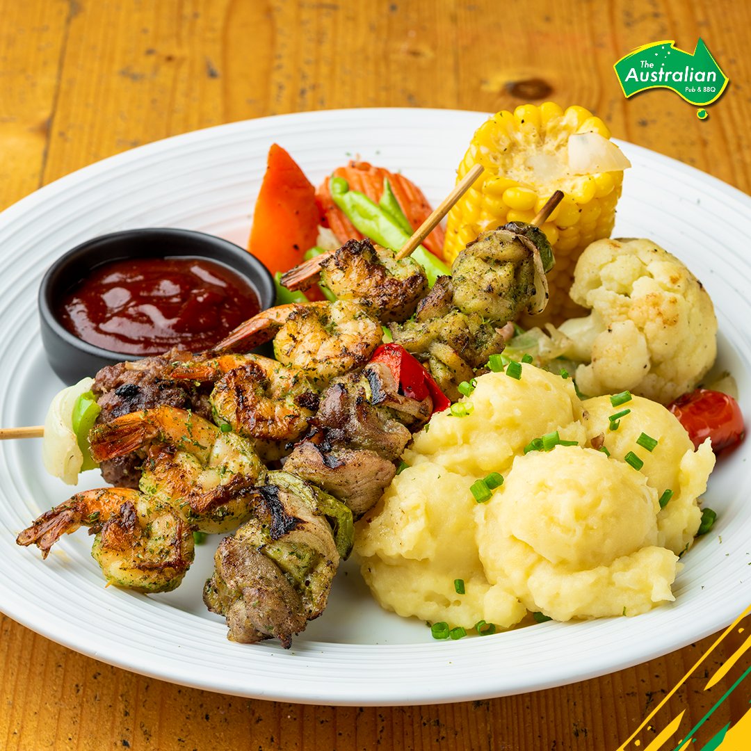 Our yummo Surf &amp; Turf plate includes char-grilled shrimp, crocodile &amp; beef rissole skewers plus sides, for just 395 baht!
