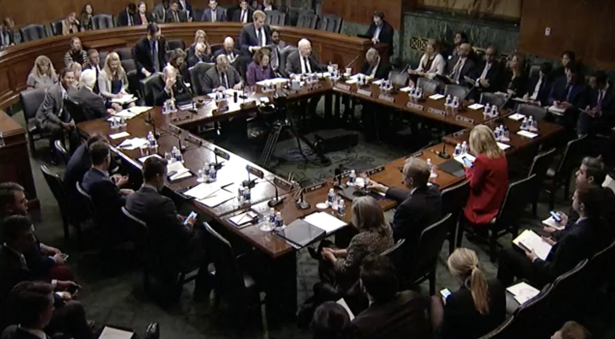 Screenshot of Senate Judiciary Committee livestream showing senators sitting around a table and voting on nominees.