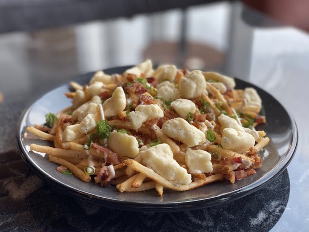 Indulge in our #StPatricksDay specials all weekend long, from March 14th to March 17th! You won't regret it. 😉 [Loaded Fries: Local Cheese Curds, Fries, Chopped Bacon, Scallions, Chef's Favorite Cheese Sauce]