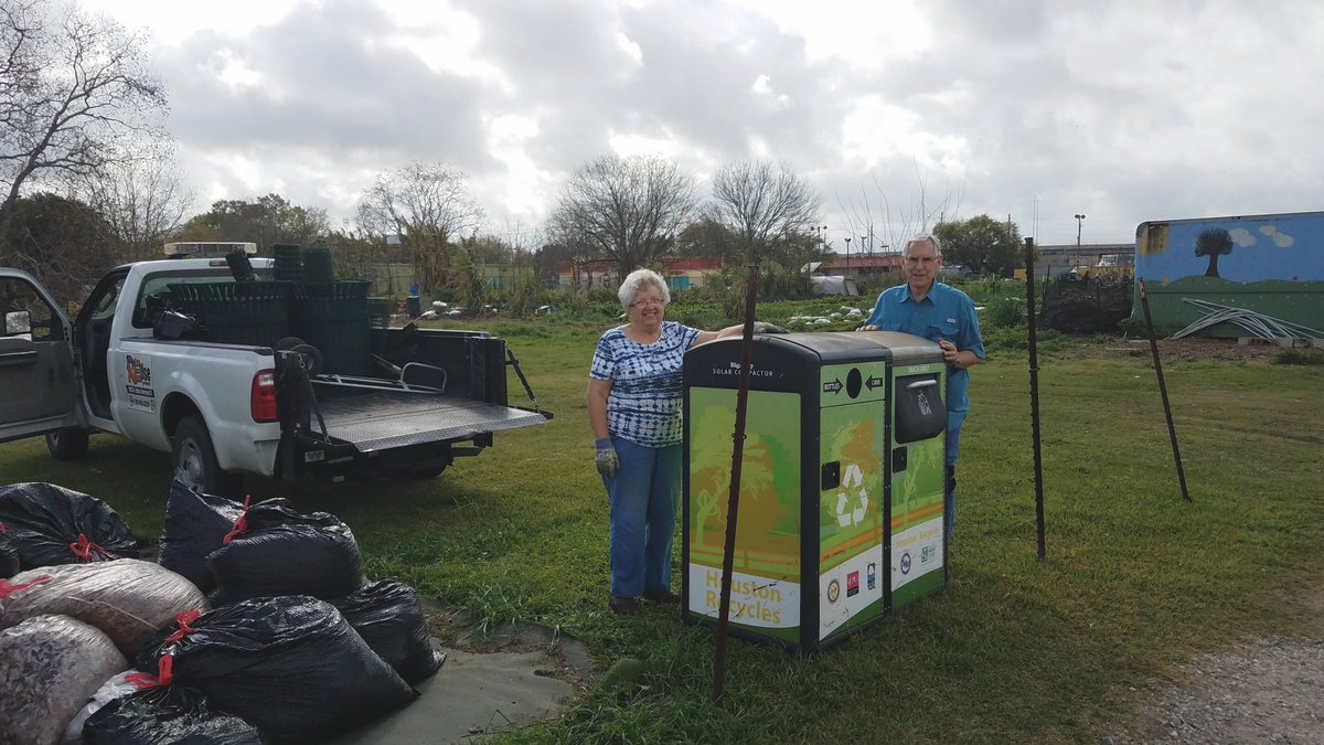 Volunteers at the Westbury Community Garden admire their solar waste compacter and other implements diverted from landfills, courtesy of the City of Houston Solid Waste Management Community Outreach team.