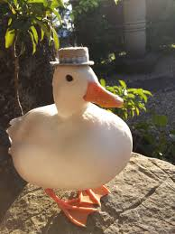 This duck is very round AND ALSO has a dapper hat so basically it's doing better at life than any of us.