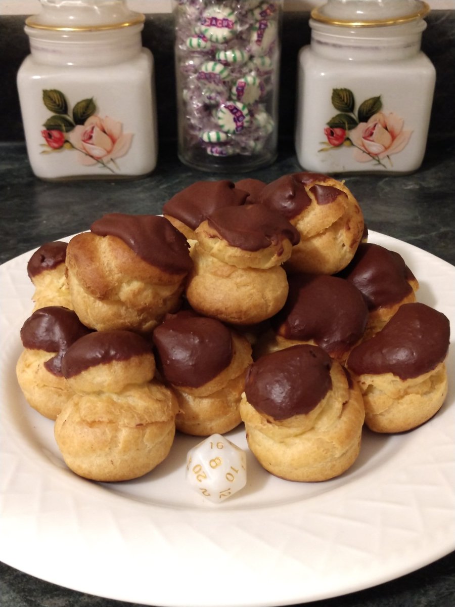ezbakeslayer's tweet photo. Tried my hand again at some profiter-de-rolos. Topped with dark chocolate and filled with creme patisserie with spiced rum. I can't wait until these babies are frozen. #CriticalRole #TheSlayersCake #Critters https://t.co/8PaZW5DA4k
