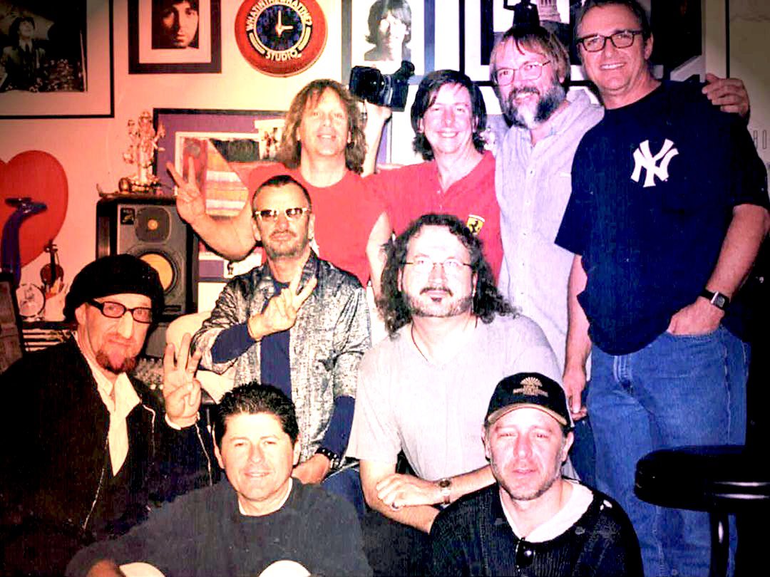 paulsantomusic's tweet photo. How can you not post a pic with Ritchie Starkey and crew featuring @markohudson 
wearing a prosthetic plastic nose appliance?
L2R:

#markhudson #jeffchonis #ringo  #paulsanto #brentcarpenter #garyburr #deangrakal #jimcox #stevedudas
#beatles https://t.co/rMB7CBA1g7