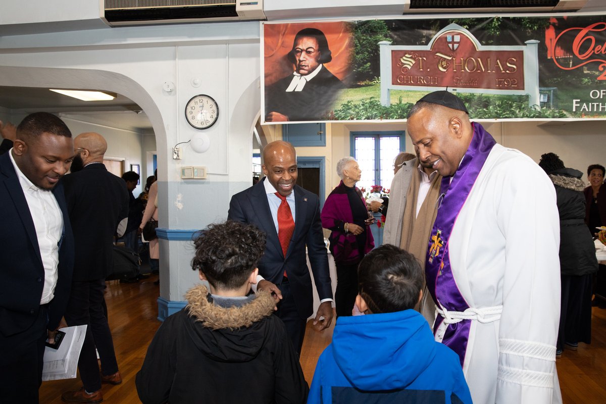 Alphonso David speaking with members of the church