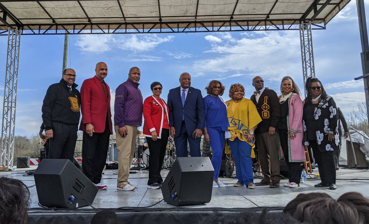 Representatives from the Divine Nine sororities and fraternities appear on stage in Selma, Alabama wearing colors that represent their organizations.