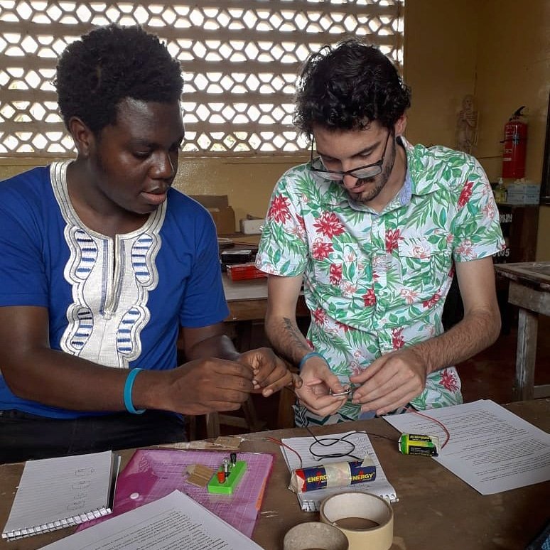 PCLiberia's tweet photo. #Science Lab #Volunteers always have to test out their #experiments before carrying the activity into the classroom. PCVs Paye and Ty are planning an #electrical circuit #lab. They co-teach labs with local teachers weaving in critical thinking and kinetic #learning. #peacecorps https://t.co/KzgcrkuDCz