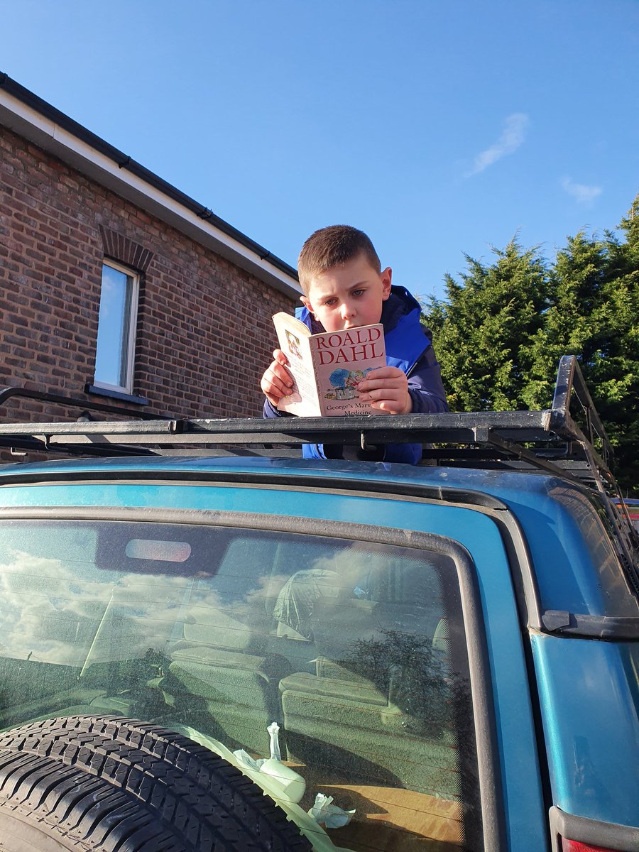 grugel23's tweet photo. @FPS_3_Charlies #bookweek2019 #extremereadingchallenge Rhys Edwardson taking part in his extreme reading challenge for Mrs Ashton's class by reading his Roald Dahl book on top of his dad's land rover. https://t.co/FL09M3XUN7