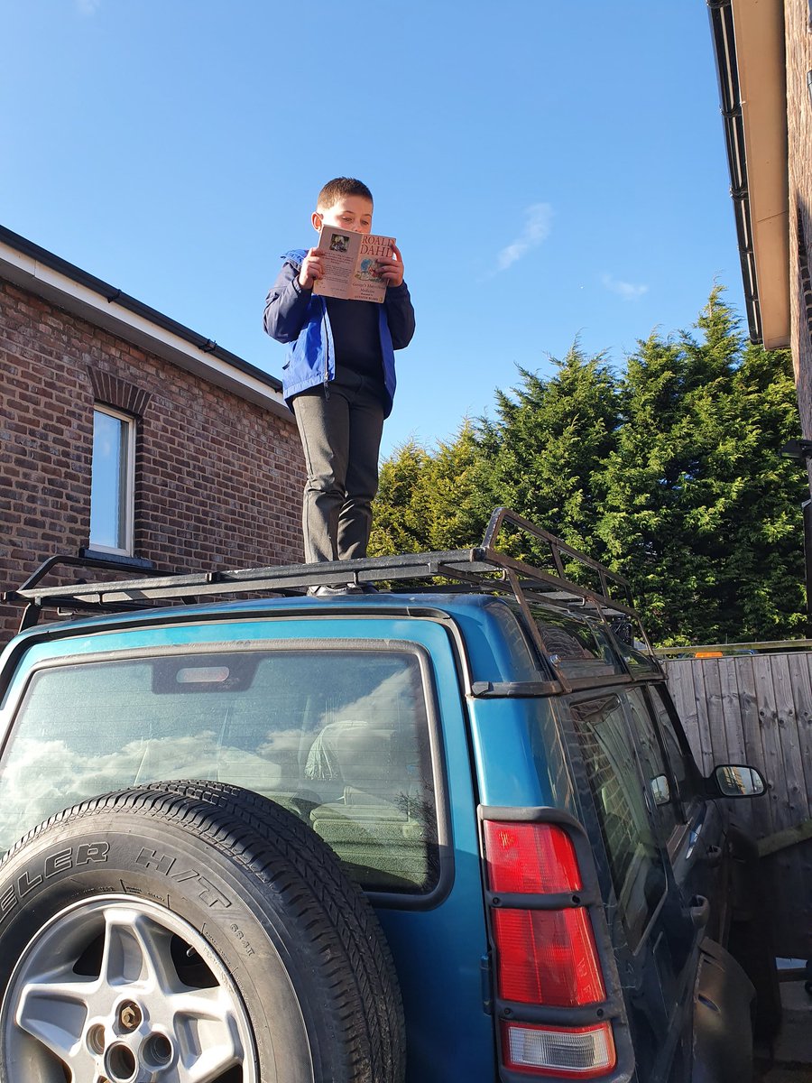 grugel23's tweet photo. @FPS_3_Charlies #bookweek2019 #extremereadingchallenge Rhys Edwardson taking part in his extreme reading challenge for Mrs Ashton's class by reading his Roald Dahl book on top of his dad's land rover. https://t.co/FL09M3XUN7