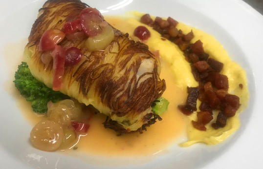 Potato wrapped halibut Veronique with sweet corn purée and a crisp pancetta