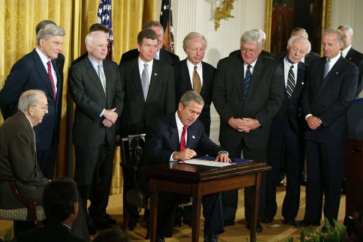 GravelInstitute's tweet photo. Joe Biden proudly looking on as the authorization for the Iraq War he championed is signed into law. https://t.co/9nW4fDSNwx