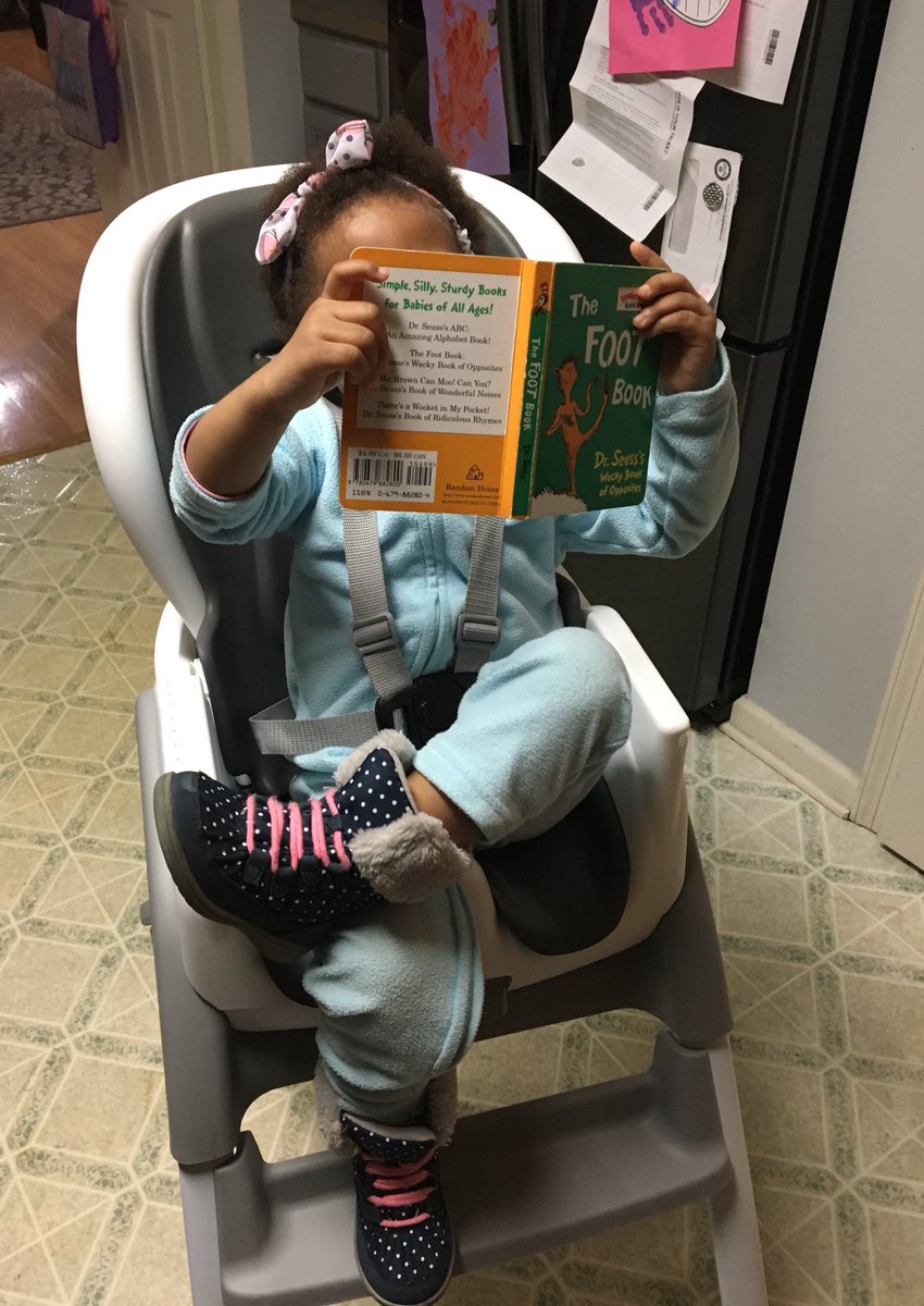 PrecPetty's tweet photo. Happy Dr. Seuss Day! Here’s a pic of my 2-year-old niece reading (with her legs crossed, thank you very much 😂) The Foot Book — one of her favorites — before dinner at Grammy &amp; Grandpa’s house. #DrSeussDay https://t.co/KVhg5lInPi