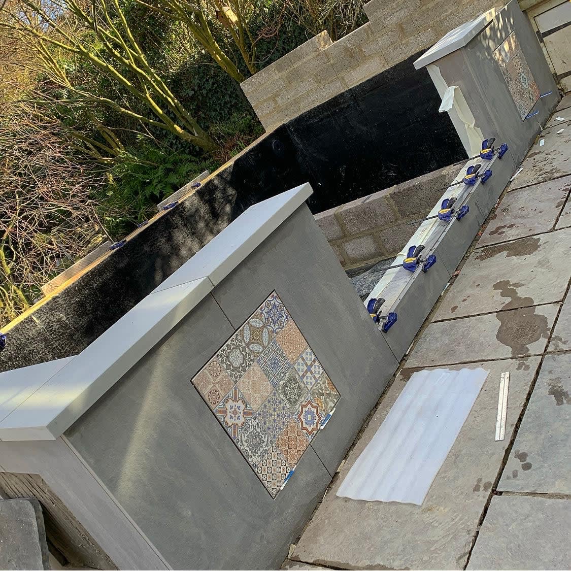 Construction almost finished on this raised pond with window. Really loving the feature tiles! Next stage installing the window! Excited to see this project finished. Finished pictures to come soon!!  #Pond #koipond #gardendesign #pondwindow #tiles #waterfeature #lanscaping